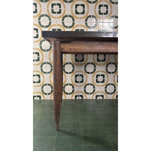 Extendable formica table with wooden legs.