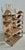 This Mario Lopez Torres small hanging wall etagere is crafted from hand-woven rattan and features distinct crescent moon...