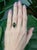 A captivating 4.1 carat black opal glows with rich, shifting colors, beautifully complemented by earth-mined diamond...