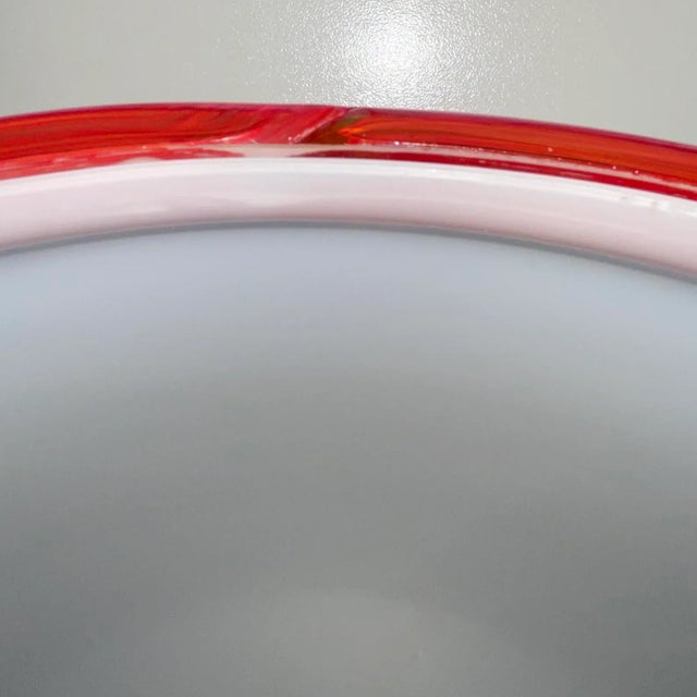 Ettore Sottsass Attributed Pendant Light by Vistosi. Murano Glass in Opal White and red glass ribbon edge. This piece is...
