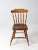 This is a vintage lodge style Windsor dining chair. The wood tavern chair features classic a turned spindle back, splay...