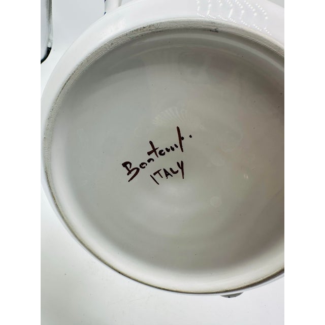 This is a hand-painted Italian ceramic serving bowl, distinguished by its cheerful decoration and traditional...