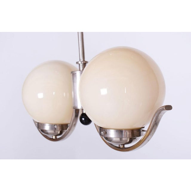 This chandelier is a refined example of functionalist minimalism and the influence of the Bauhaus movement in 1930s...