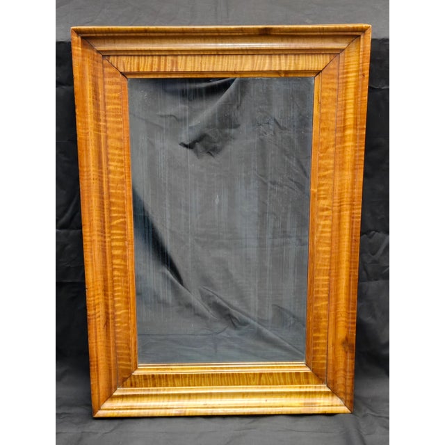 A stunning tiger maple frame makes this mirror really shine, richly colored with a beautiful grain pattern throughout....