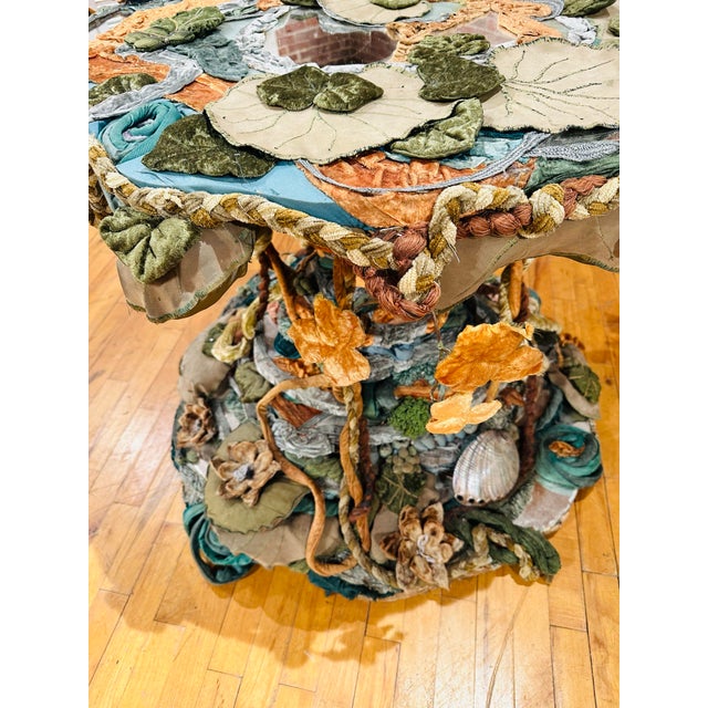 This artist-crafted table is a breathtaking work of functional art, blending intricate textile craftsmanship with...