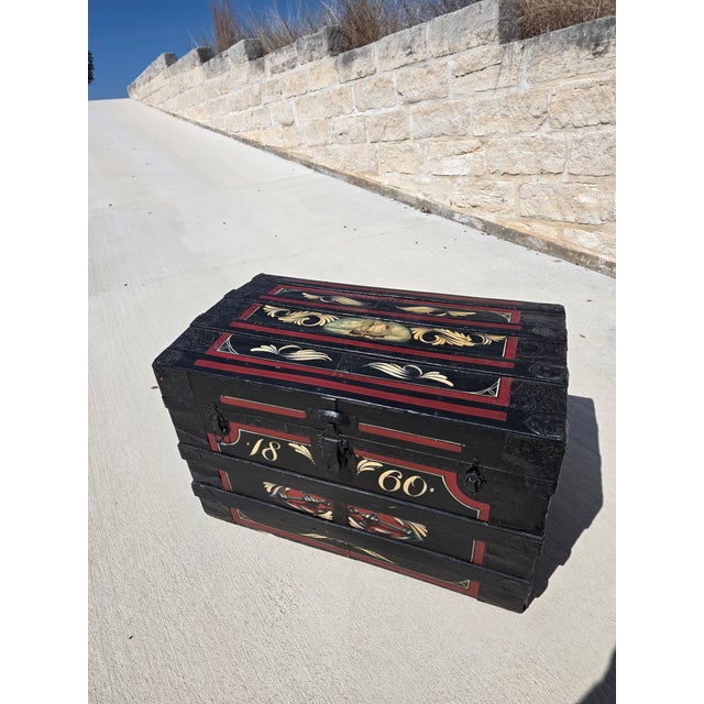 Antique trunk with painted metal canvas and leather trunk. This would make a wonderful coffee table.