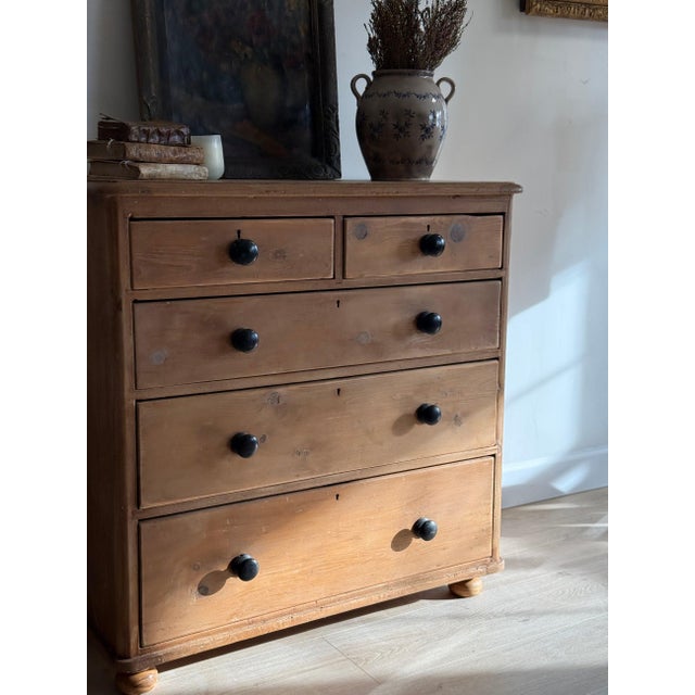 Five-drawer English pine chest in the classic Victorian two-over-three configuration, ebonised turned knobs set against...
