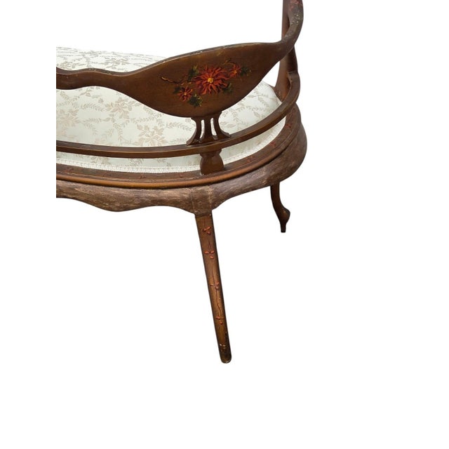 A beautifully romantic French Louis XV-style settee, distinguished by its graceful curved frame, elegant cabriole-style...