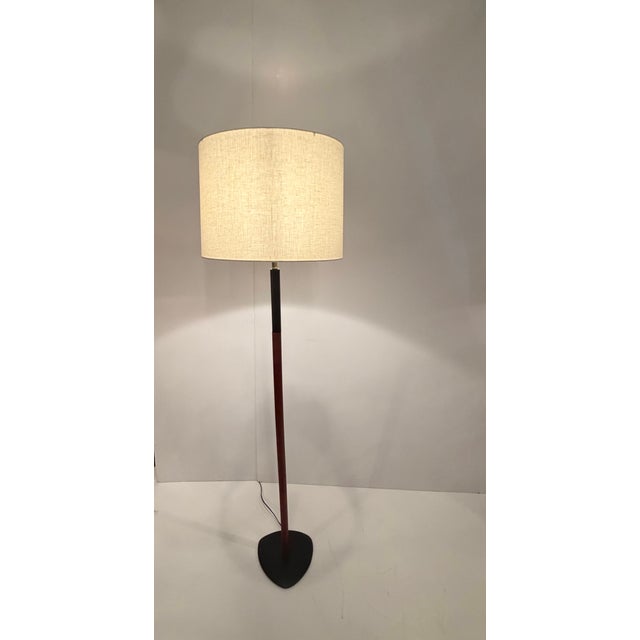 Sleek sophisticated Danish Modern mid-century ebonized wood and teak floor lamp with iron base.