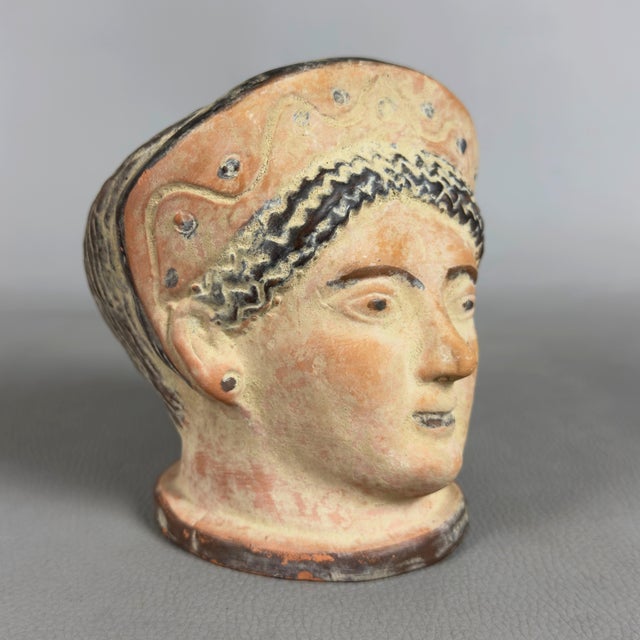 A striking decorative terracotta artifact with archaeological appeal, a classically styled reproduction attributed to...