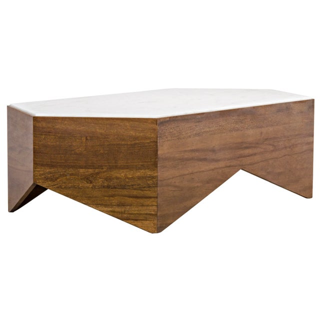 Topped with a hexagon of marble, the base of this curious coffee table has been hand-carved of walnut. The wood is cut...
