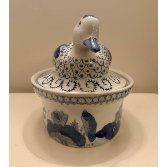 This vintage Chinese export style porcelain from the mid-20th century is decorated with hand-painted blue and white...