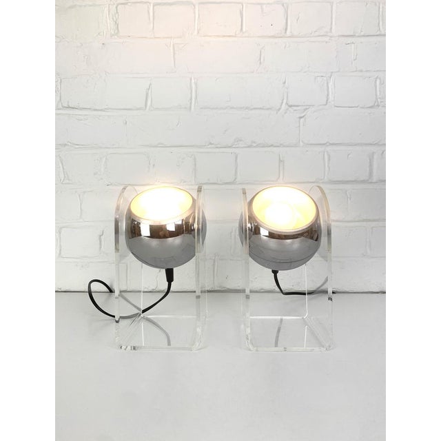 Pair of Space Age table lamps designed in the style of Gino Sarfatti for Arteluce. A chromed ball is hold by a folded...