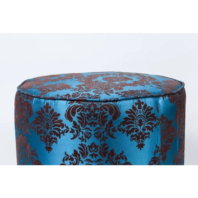 A bold and glamorous Moroccan round ottoman or vanity stool in blue with black velvet damask upholstery, featuring a...
