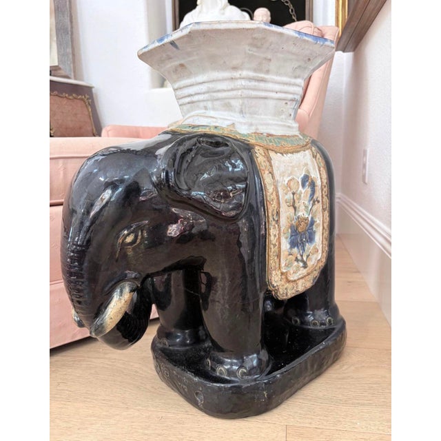 Impressive vintage Asian-inspired glazed ceramic elephant garden stool featuring a striking glossy black finish and an...