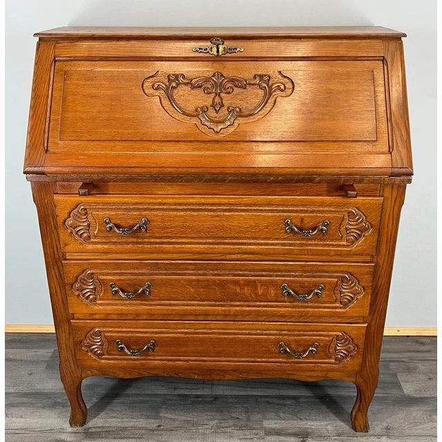 Bring classic French sophistication into your home with this charming vintage oak bureau writing desk. Featuring a...