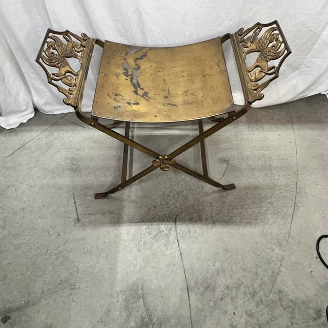 Fabulous 1940’s Oscar Bach Style iron with plated brass stool / bench. Features opposing winged griffins on each side....