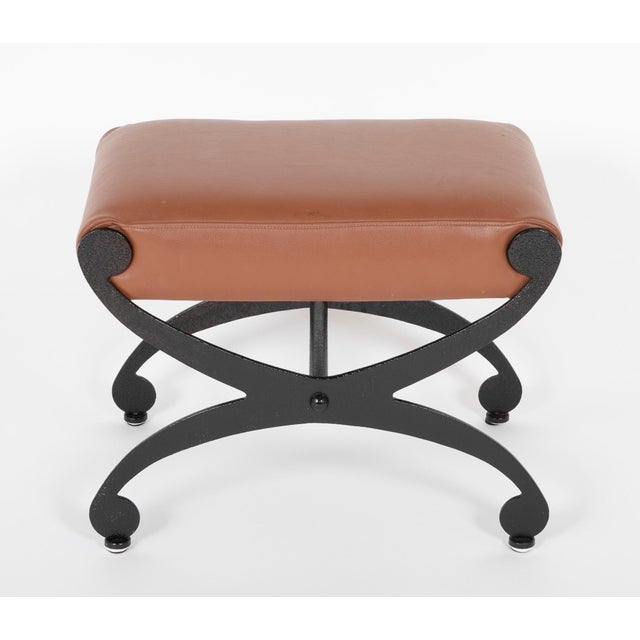 Handsome pair of Regency style steel stools with X-form bases. The steel with a blackened textured finish. Upholstered in...
