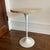 Tulip style round table. Travertine top, polished lacquered white base. Great condition.