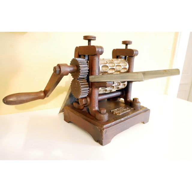 Candy machine with two bronze rollers and a cast iron frame. Monogram engraved "MSF" on the lower roller. Made by Robbi...