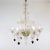 This exquisitely handcrafted gold-infused cristallo Murano chandelier has six undulating scroll arms with hanging scarlet-...