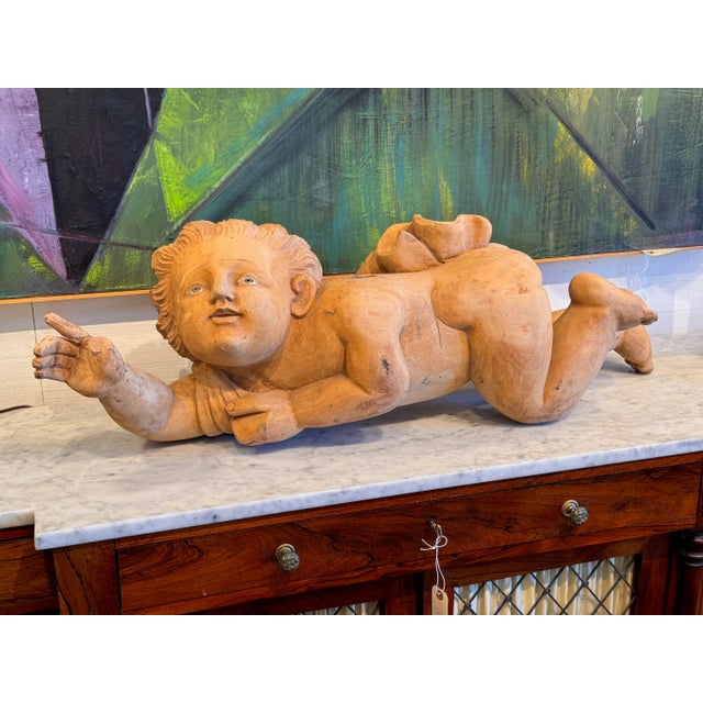 An interesting carved figure with glass eyes. No wings present.