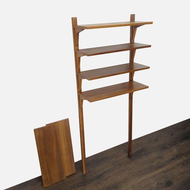 This West Elm bookshelf features a sturdy wooden frame with four spacious shelves, perfect for books, decor, or storage....