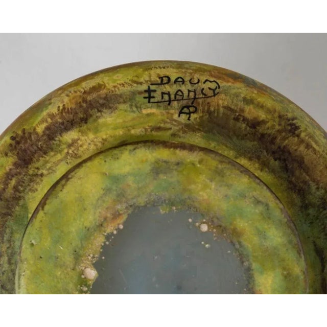 Small vase with flattened body in marbled glass multilayer acid-etched with polychrome decoration of a wooded meadow in a...