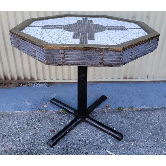 This fine inlaid pedestal table has custom inlaid tiles with the New Mexico sign on top.The base is in a blue pieced wood...