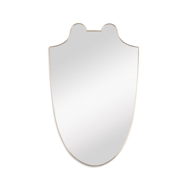 The antique brass finish Italian shield mirror of grand scale reflects the classical and Renaissance influences that have...