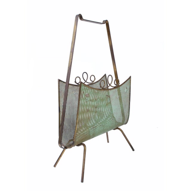 In the style of Mathieu Matégot Magazine rack in distressed condition.