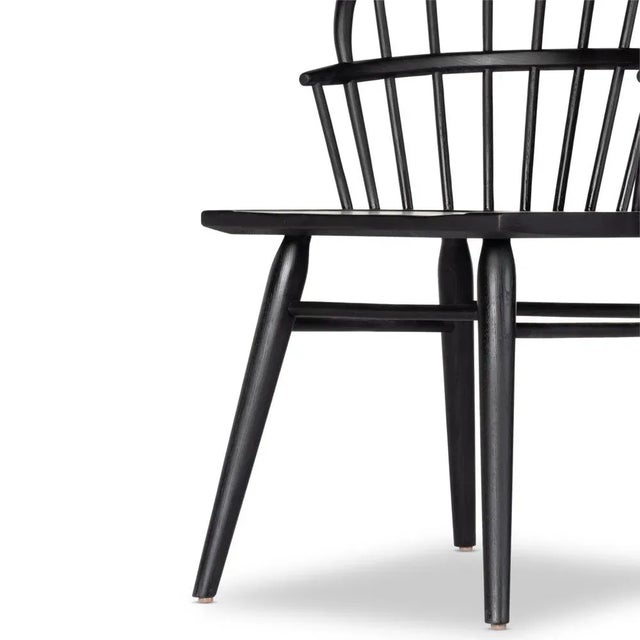 The classic Windsor, modernized. Seating of black-finished solid ash features a double-tiered back and finely sculpted...