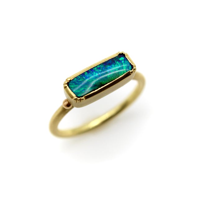 Designed by Brooke Gregson, this 18k gold ring features a rectangular boulder opal in a simple bezel setting. The ring’s...