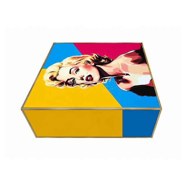 A striking storage table featuring a pop art graphic inspired by marilyn monroe. entirely handmade, the glass-covered...