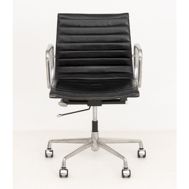 Charles and Ray Eames Aluminum Group Office Chair, model EA117, the black leather upholstered adjustable swivel chair on...
