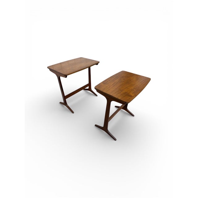 This rare set of two Mid-Century Danish Modern nesting tables by Selig, designed by Poul Jensen, embodies the refined...