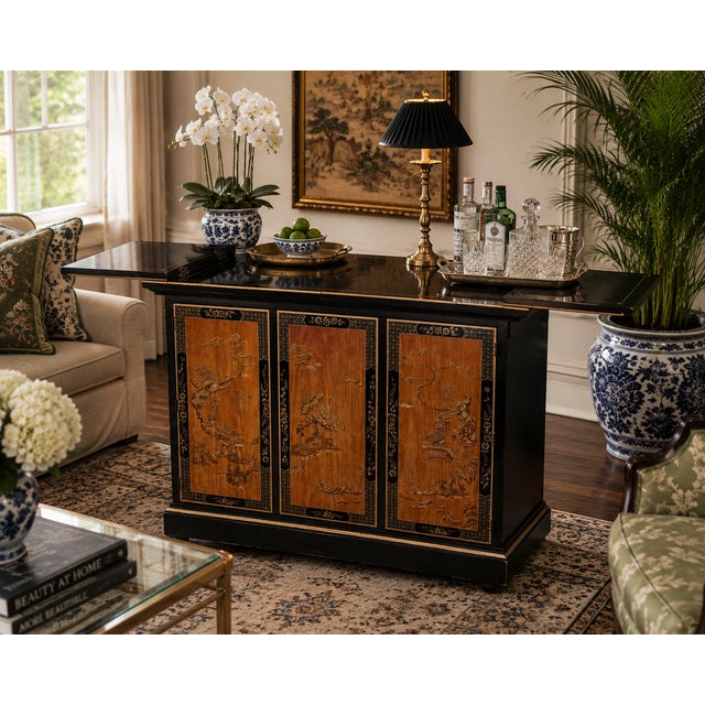 A refined chinoiserie bar cabinet by Drexel Heritage, combining classic Eastern-inspired motifs with tailored American...