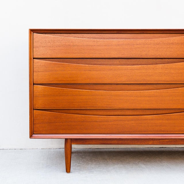 Iconic and expertly restored eight drawer teak lowboy dresser or credenza from Arne Vodder’s “Triennale” collection, made...