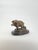 Snack Time is a charming bronze sculpture that captures a playful moment in the wild—a bear proudly clutching his catch, a...