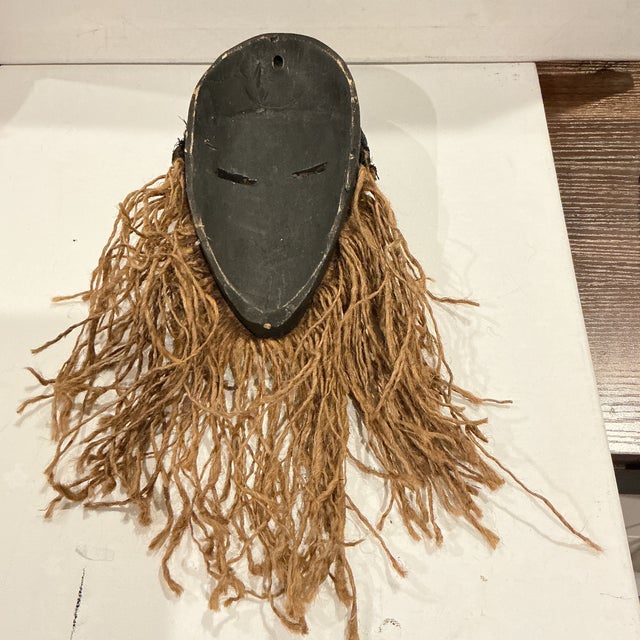 A traditional African hand carved wood tribal mask of the Dan people, a Mande ethnic group from northwestern Ivory Coast...