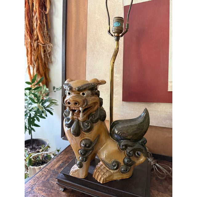 This striking vintage Chinese Foo Dog table lamp features a beautifully glazed ceramic guardian lion mounted on a stained...