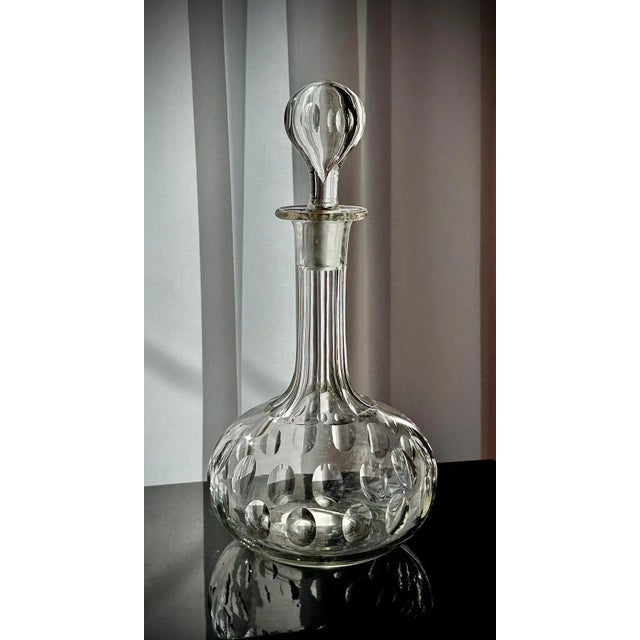 A late 19th-century Victorian glass decanter in classic shaft and globe form, likely English, circa 1880. The piece has a...