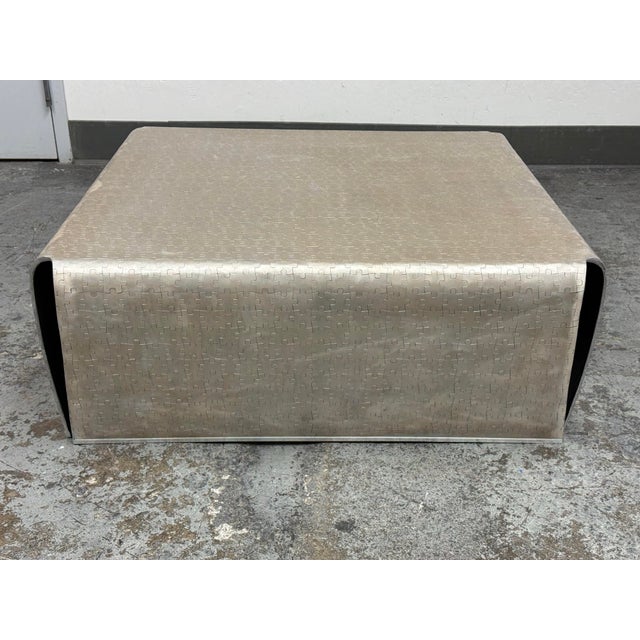 Design Plus Gallery presents a Puzzle-Piece Cutout Pattern Metal Coffee Table. The square form is composed of curved metal...