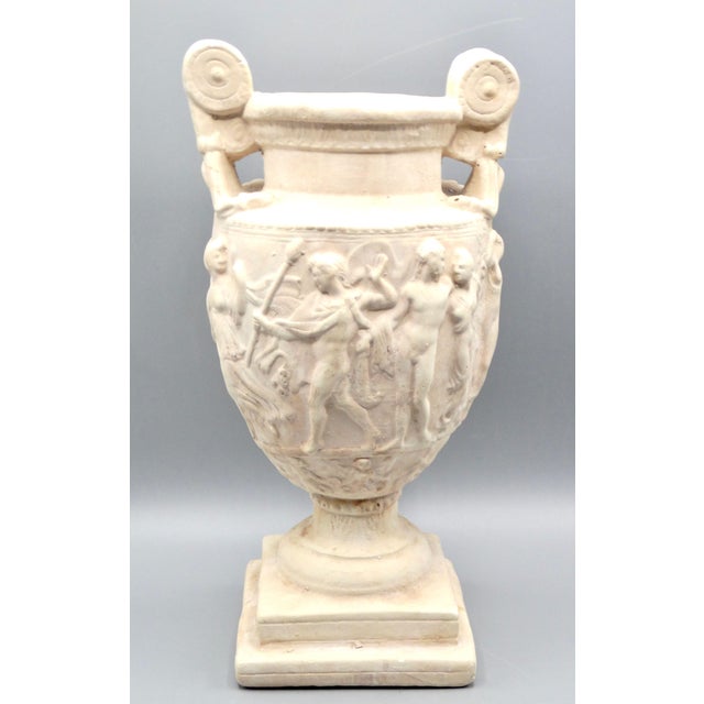 Large figural Greek Grand Tour style vase on a stepped pedestal base. This urn has detailed with Greek / Roman figures in...