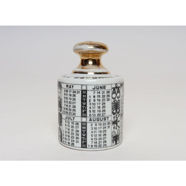 Vintage Italian porcelain "1964" paperweight with calendar by Piero Fornasetti. Lithographic and gilt decoration with...