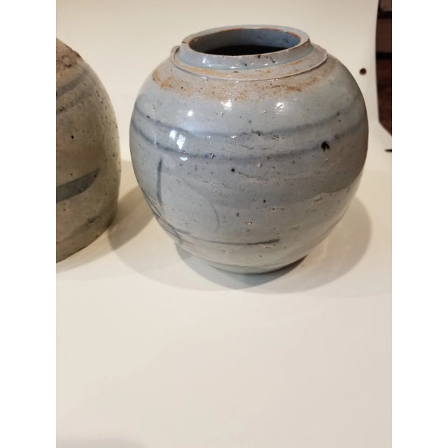 One blue and blue gray and another darker one...possibly Korean. The larger one is 5.5" tall and 5.5"w. The other is 5" by...