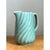 This vintage aqua swirl ceramic pitcher presents a compact, softly tapered silhouette, with a rounded belly that narrows...
