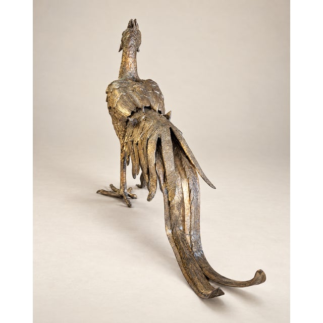 An elegant vintage rooster sculpture featuring intricate feather detailing, a proud upright stance, and dramatic sweeping...