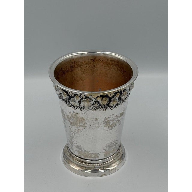 Refined silver plate cup or small vessel designed in a neoclassical revival style, distinguished by its elegant...