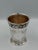 Refined silver plate cup or small vessel designed in a neoclassical revival style, distinguished by its elegant...